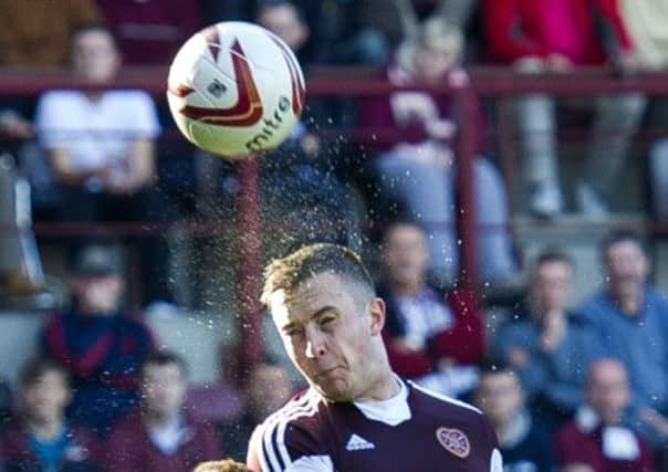 Hearts captain Danny Wilson gets above the Dundee United defence. Picture: SNS