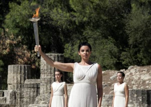 Actress Ino Menegaki holds the Olympic Torch during the final dress-rehearsal of the flame lighting ceremony at Olympia. Picture: Getty