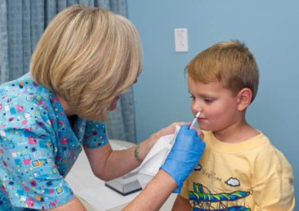 A child receives a nasal flu vaccine. Picture: Contributed