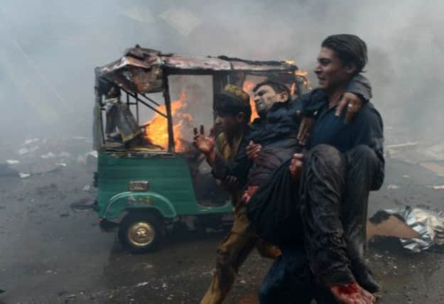 A man injured in the blast is carried to safety. Picture: Getty