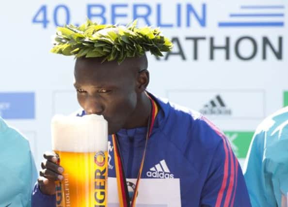 Kenyas Wilson Kipsang sips a welldeserved beer on the podium yesterday. Picture: Getty
