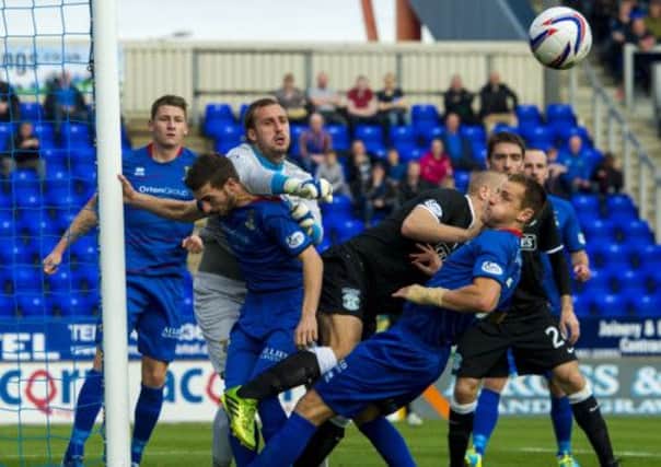 Inverness goalkeeper Dean Brill punches the ball clear of a crowded goalmouth. Picture: SNS Group