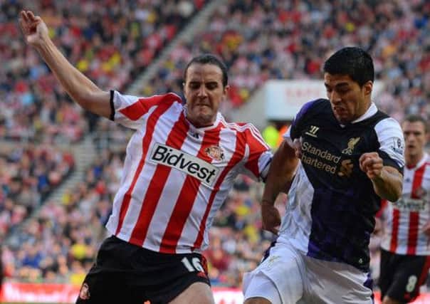 Sunderland defender John OShea vies with Liverpool striker Luis Suarez. Picture: Getty