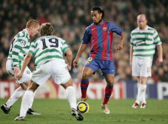 Neil Lennon tries to get to grips with Ronaldinho in 2004.  Tonight the Celtic manager will look for a second win over Barcelona as manager. Picture: Getty
