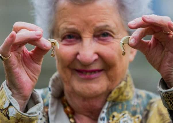 Margaret Laing with the lion cufflinks. Picture: Hemedia