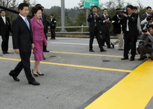 South Korean president Roh Moo-Hyun and his wife cross the demilitarised zone border en route to North Korea in 2007. Picture: AFP/Getty