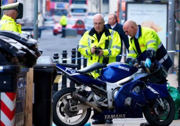 Police inspect the wreckage of the bike involved in the accident that resulted in the death of a pedestrian in Edinburgh. Picture: Joey Kelly