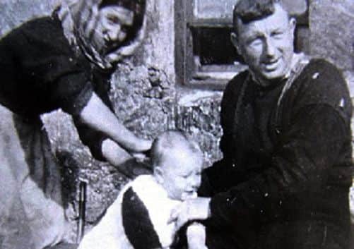Norman Gillies as a baby on St Kilda with his mother Mary and father John. Picture: Comp