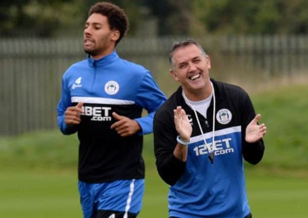 Wigan Athletic manager Owen Coyle enjoys an amusing moment in training, alongside right-back Ryan Shotton  yesterday. Picture: PA