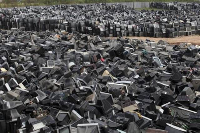 Discarded television sets pile up in a scrap yard awaiting recycling in Zhuzhou city in south China's Hunan province. Picture: AP