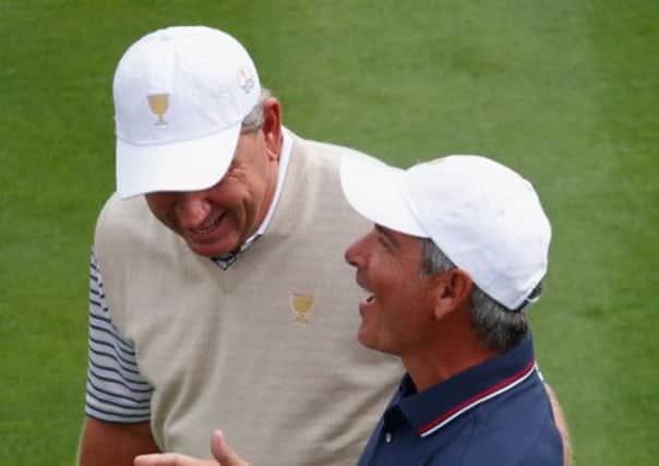 Internationals captain Nick Price presents a cake to his US counterpart Fred Couple. Picture: Getty Images
