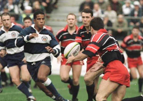 Bath's Jeremy Guscott, left, lines up a tackle as Scott Hastings, centre, passes at the Rec in the 1996 European Cup clash. Picture: Getty