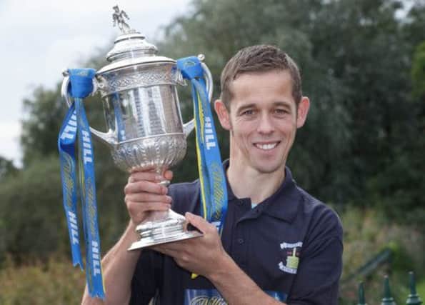 David Bingham gets a hold of the Scottish Cup ahead of Preston's trip to Hampden today. Picture: Steve Welsh