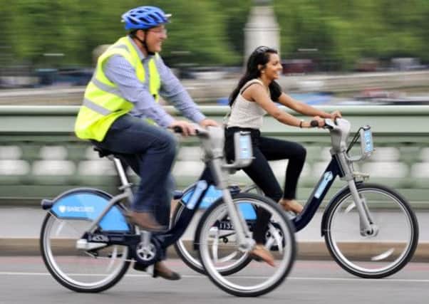 Two cyclists on so-called 'Boris Bikes'. A similar scheme could come to Glasgow. Picture: PA