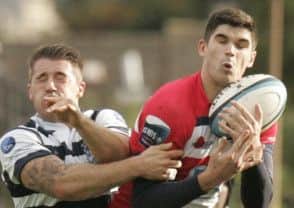 Steven Aitken outmuscles Heriot;s Max Learmonth. Picture: Toby Williams