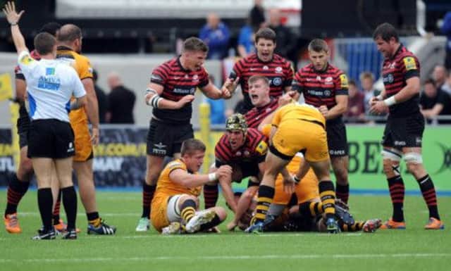 Saracens celebrate as Scotland captain Kelly Brown (in scrum cap) creates a turnover against Wasps. Picture: PA