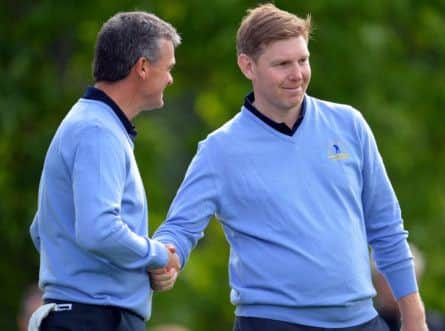 Paul Lawrie and Stephen Gallacher of Great Britain and Ireland shake hands after their win. Picture: Getty