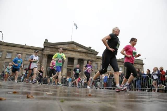 Competitors pass old court building during the Half Marathon Picture: PA