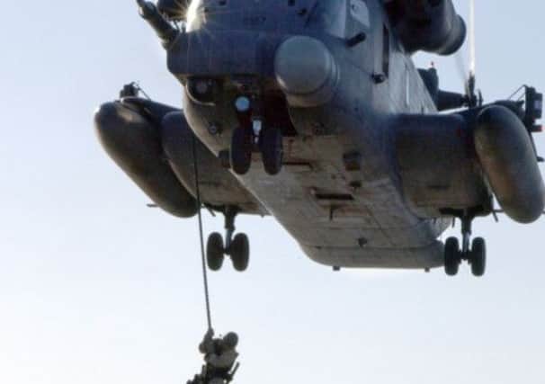 US navy Seals drop from a helicopter during an exercise. The elite force includes the covert special operations group that carried out Saturday's raids. Picture: Getty