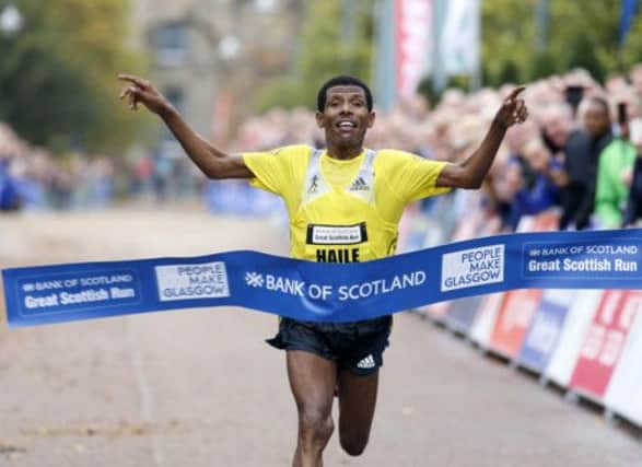 The great Haile Gebrselassie takes the tape to claim a new world record in the Great Scottish Run. Picture: PA