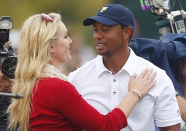 Tiger Woods celebrates with girlfriend Lindsey Vonn on the 18th hole. Picture: Reuters