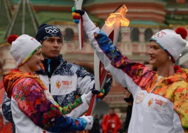 Anastasia Davydova, left, and world and gymnast Svetlana Khorkina, hold the Olympic torches. Picture: AFP