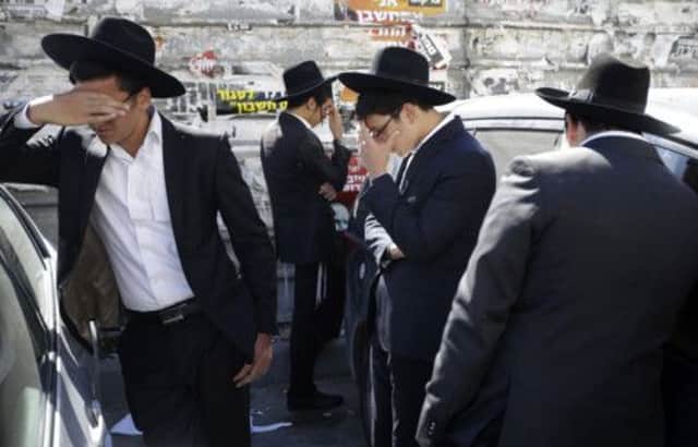 Followers of sage and politician Rabbi Ovadia Yosef grieve outside his home in Jerusalem yesterday. Picture: AP