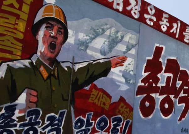Propaganda posters point the way to the ski slopes. Picture: AP