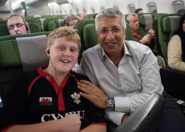 Joe with hypnotherapist Russell Hemmings on board the flight to London. Picture: Hemedia