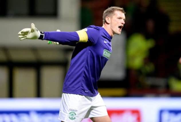 Hibernian goalkeeper Ben Williams, who made a string of important saves, urges his team on at Firhill on Monday night. Picture: SNS