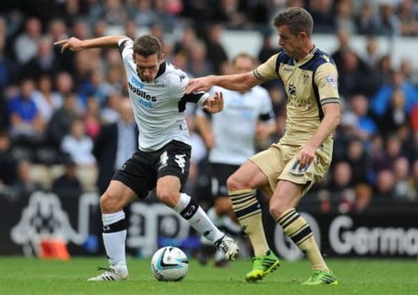 Craig Bryson, left, battles with Michael Tonge of Leeds United during Derbys 3-1 victory in the Championship last Saturday. Picture: Getty