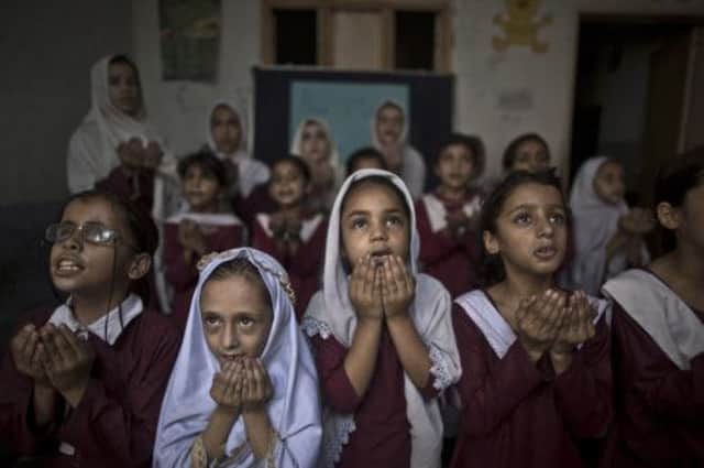Pakistani children at a Rawalpindi school chant prayers for Malala Yousafzai. Picture: AP