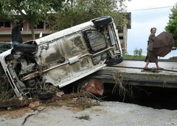 A lorry lies overturned in the Greek city of Volos after a 2006 storm which resulted in one of the worst floods recorded there. Picture: AFP/Getty