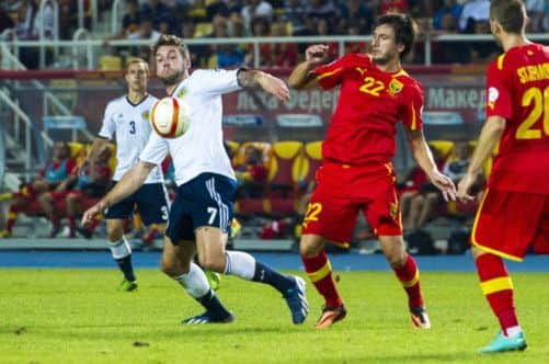 Charlie Mulgrew, left, holds off Macedonias Darko Tasevski during Scotlands moraleboosting 21 win. Picture: Alan Harvey/SNS