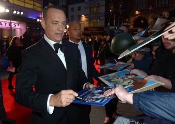 Tom Hanks signs autographs as he arrives at the European Premiere of Captain Phillips in London. Picture: AP