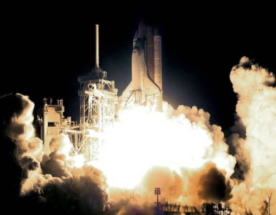 Discovery, with its a crew of seven, takes off for the International Space Station on the 100th space shuttle mission in 2000