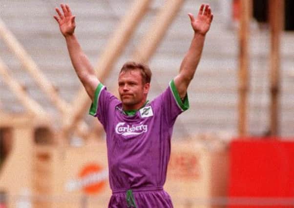 "Hands up if you think your strip's ridiculous." John Hughes turns out for Hibernian in lilac. Picture: SNS