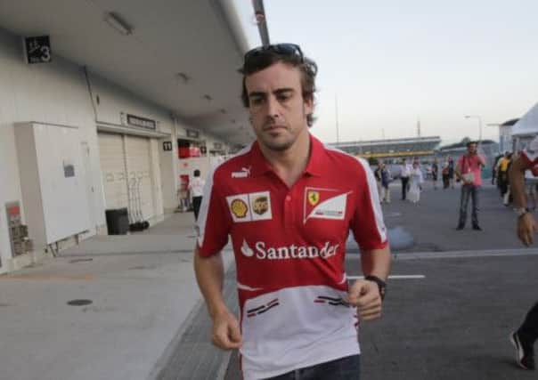 Fernando Alonso rushes to a drivers meeting yesterday. Picture: AP