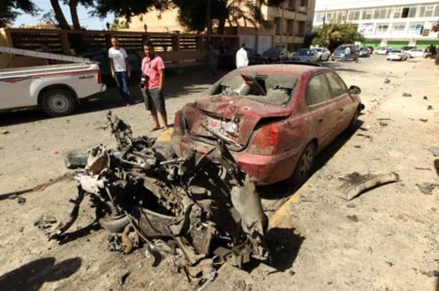 The aftermath of a car bomb explosion outside the Swedish consulate in the eastern Libyan city of Benghazi yesterday. Picture: AFP