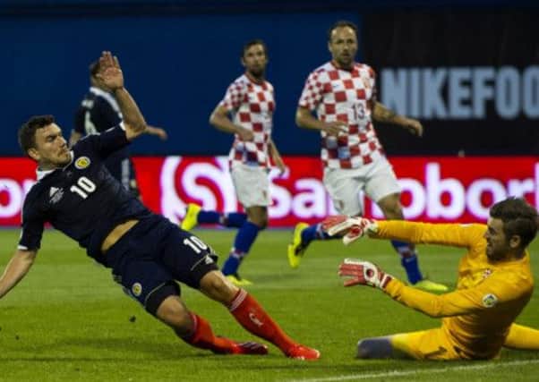 Robert Snodgrass slides the ball past Croatia keeper Stipe Pletikosa to give Scotland the lead. Picture: SNS