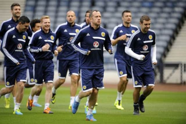 Charlie Adam and James McArthur, right, lead the Scotland squad in training at Hampden yesterday. Picture: Greg Macvean