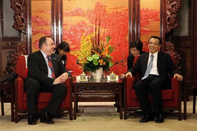 Alex Salmond, left, attempts to boost Scotlands standing on the world stage during a visit to China in 2011. Picture: AP