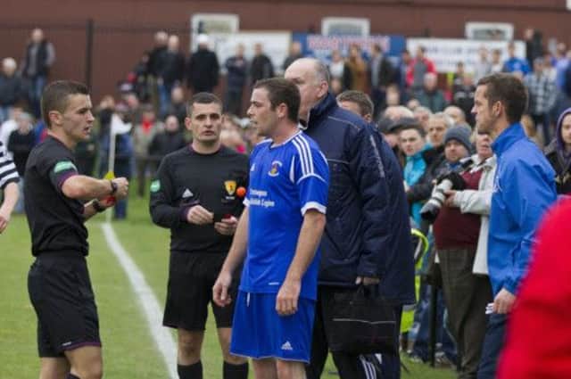 Referee Nick Walsh, far left, cautions Kieran Dodd in front of the Preston bench. Picture: Malcolm McCurrach