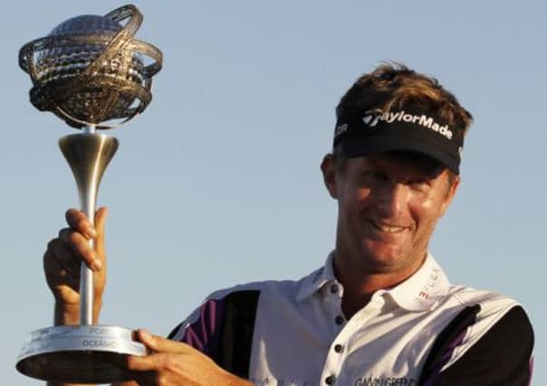 Britain's David Lynn poses with his trophy to the media after winning the 2013 Portugal Masters. Picture: AP