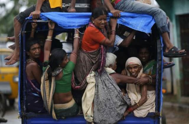 Some of those evacuated to shelters as Cyclone Phailin approached are returned to their villages. Picture: Reuters