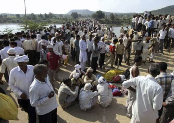 Indian villagers gather after the deadly stampede on a bridge across the Sindh River in Madhya Pradesh. Picture: AP