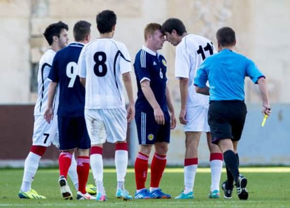 Fraser Fyvie clashes with Giorgi Kvilitaia during the Scotland Under-21s 2-1 defeat in Tbilisi yesterday. Picture: SNS