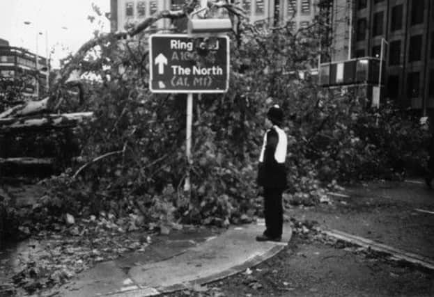 A policeman sureveys some of the damage after a hurricane hit Britain on this day in 1987, killing 18 people. Picture: Getty