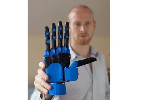 Joel Gibbard with the hand he developed for a few hundred pounds. Picture: SWNS