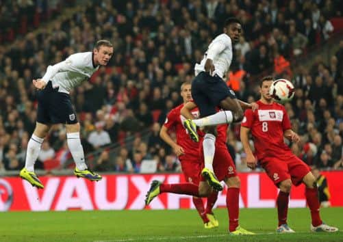 Wayne Rooney gets on the end of a cross by Leighton Baines to direct a header past Wojciech Szczesny. Picture: PA
